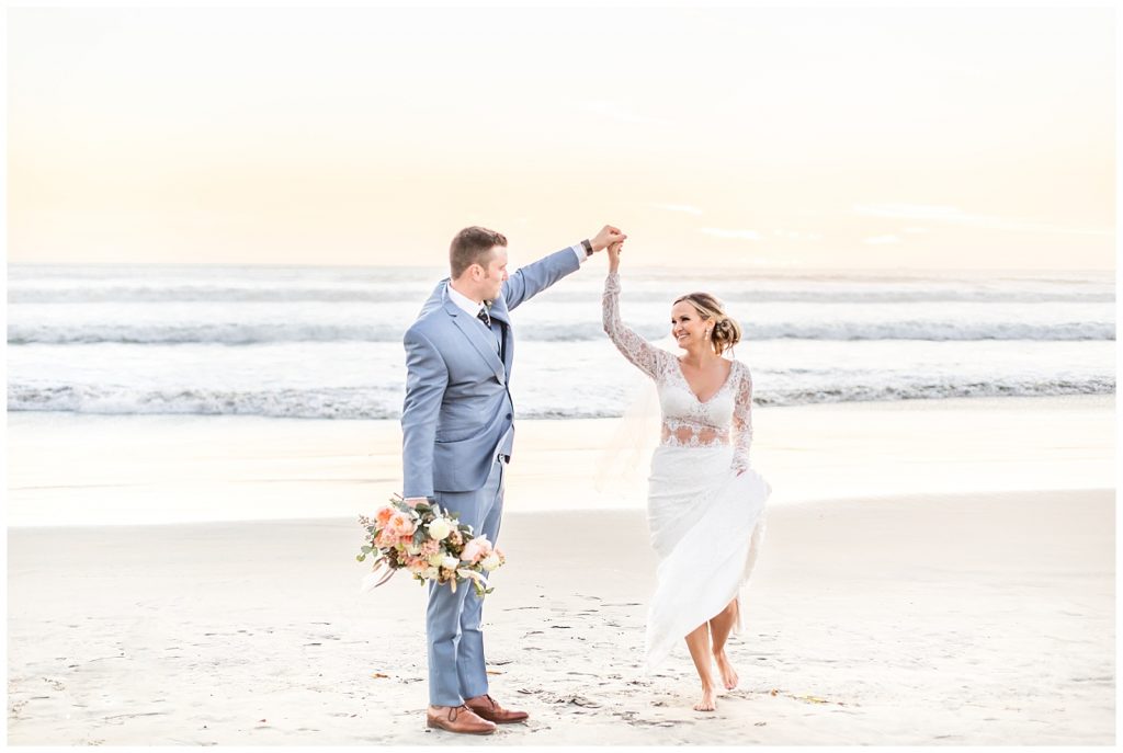 couple dancing on the beach on their wedding day
