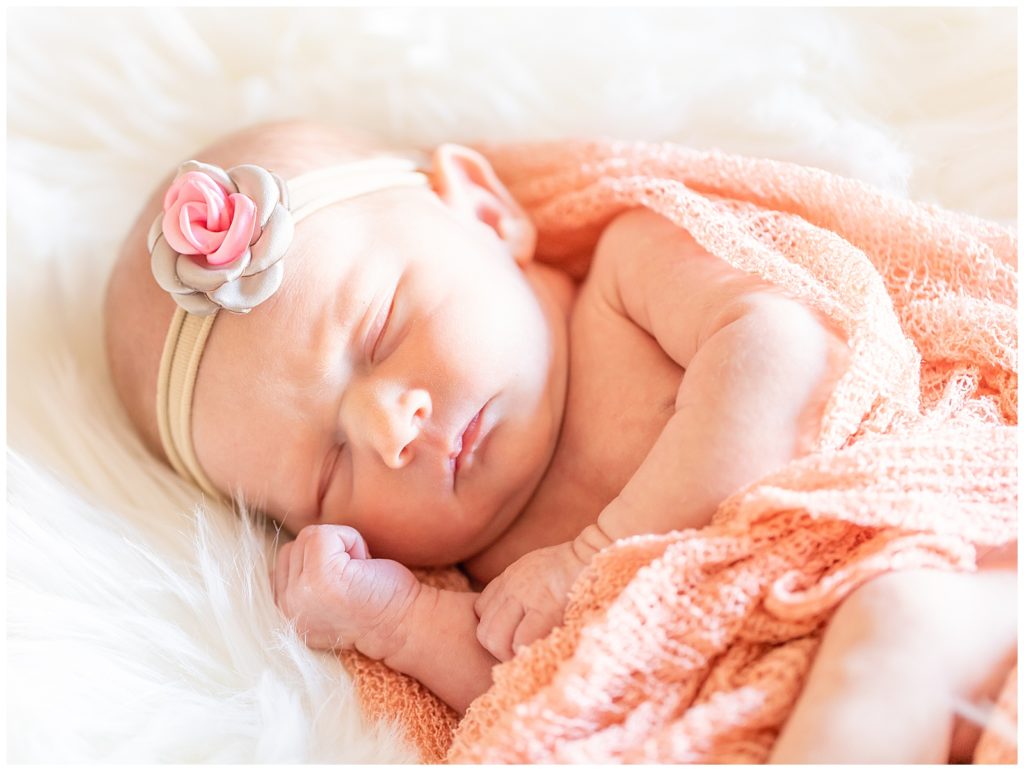 san diego newborn photo of a baby girl sleeping with a flower headband