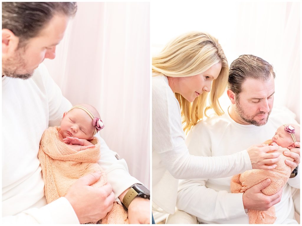 lifestyle photo of newborn baby girl being held by her mom and dad
