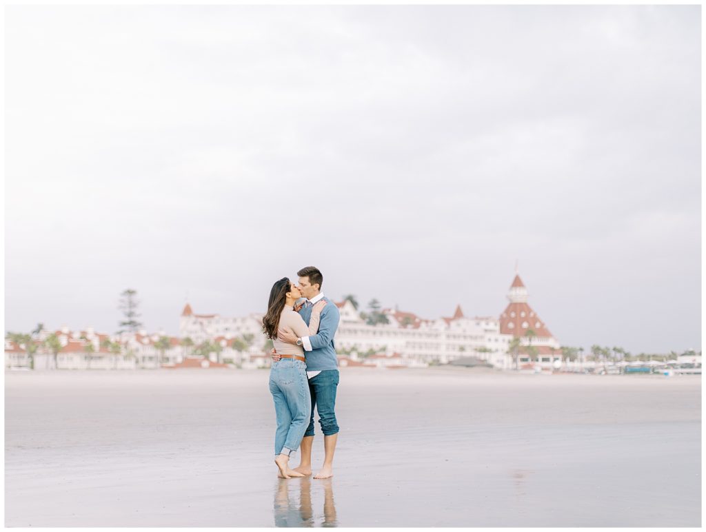 couple kissing on the beach in front of the hotel Del Coronado