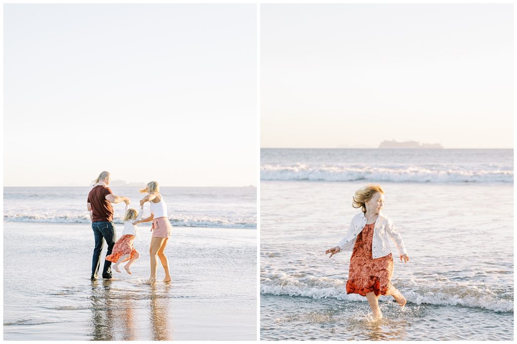 family plays in the ocean during their family photo session