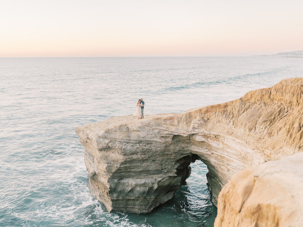 Cliffside overlooking the ocean in sunset cliffs with couple during sunset