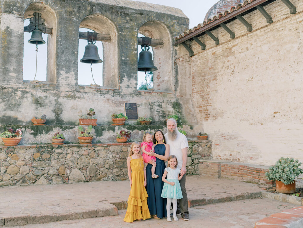 Family at the mission San Juan posing for a family photo