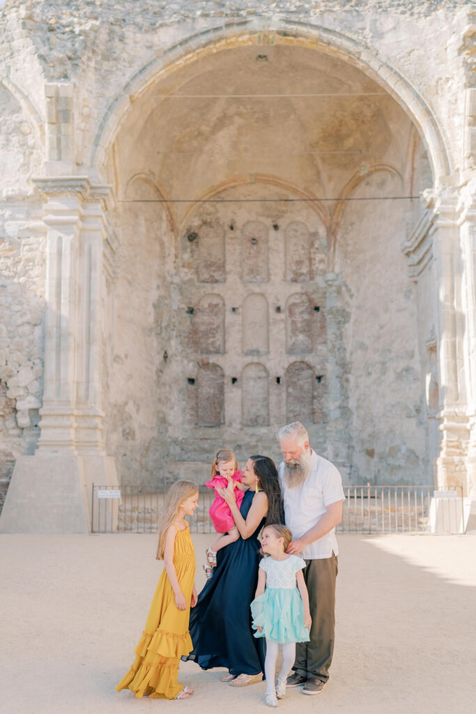 family at the mission San Juan in a group in front of a big architecture piece