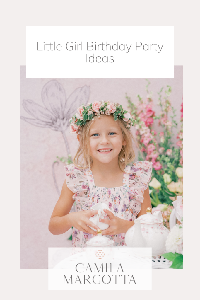 little girl smiling while holding a teacup