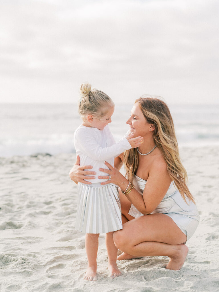 A mother smiling while looking at her daughter