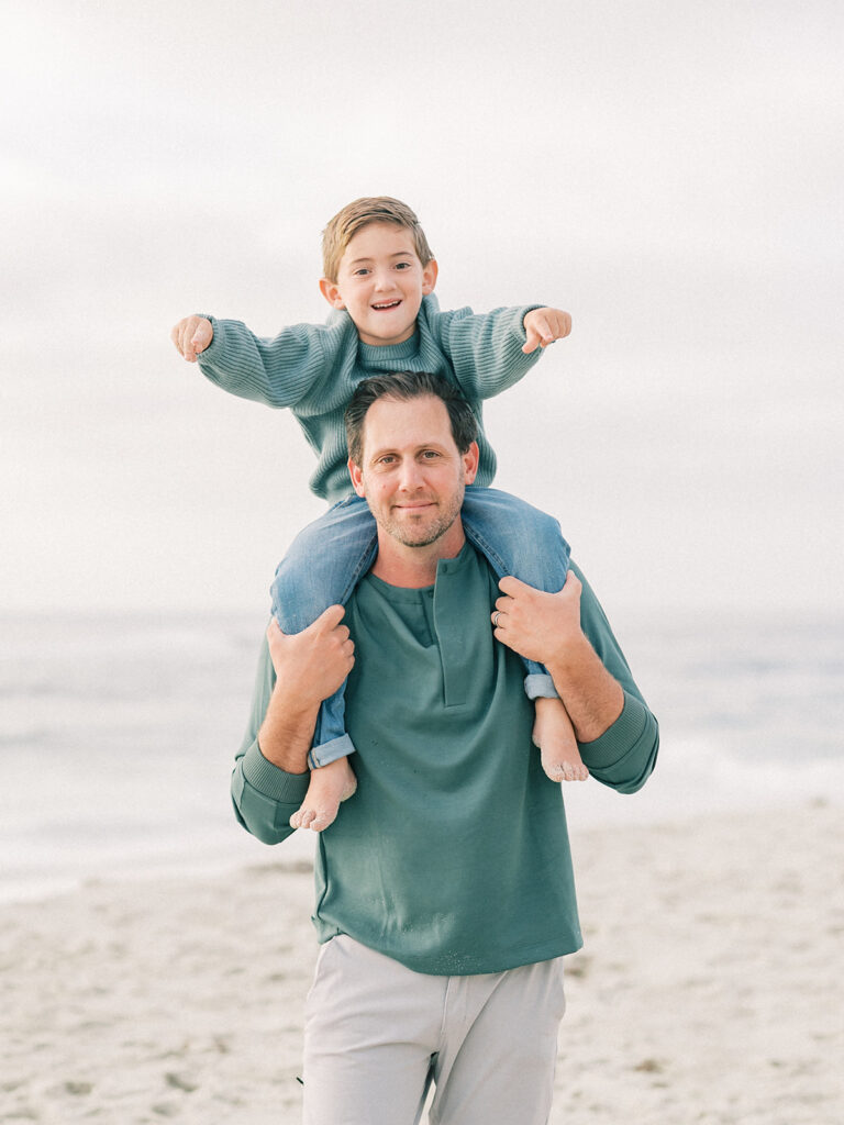 Father carrying his son on his shoulder during La Jolla family photography session