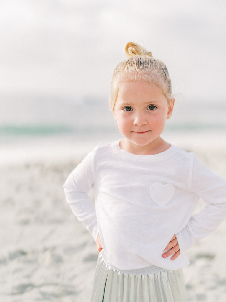 A little girl smiling subtly her expression blending joy with a touch of seriousness