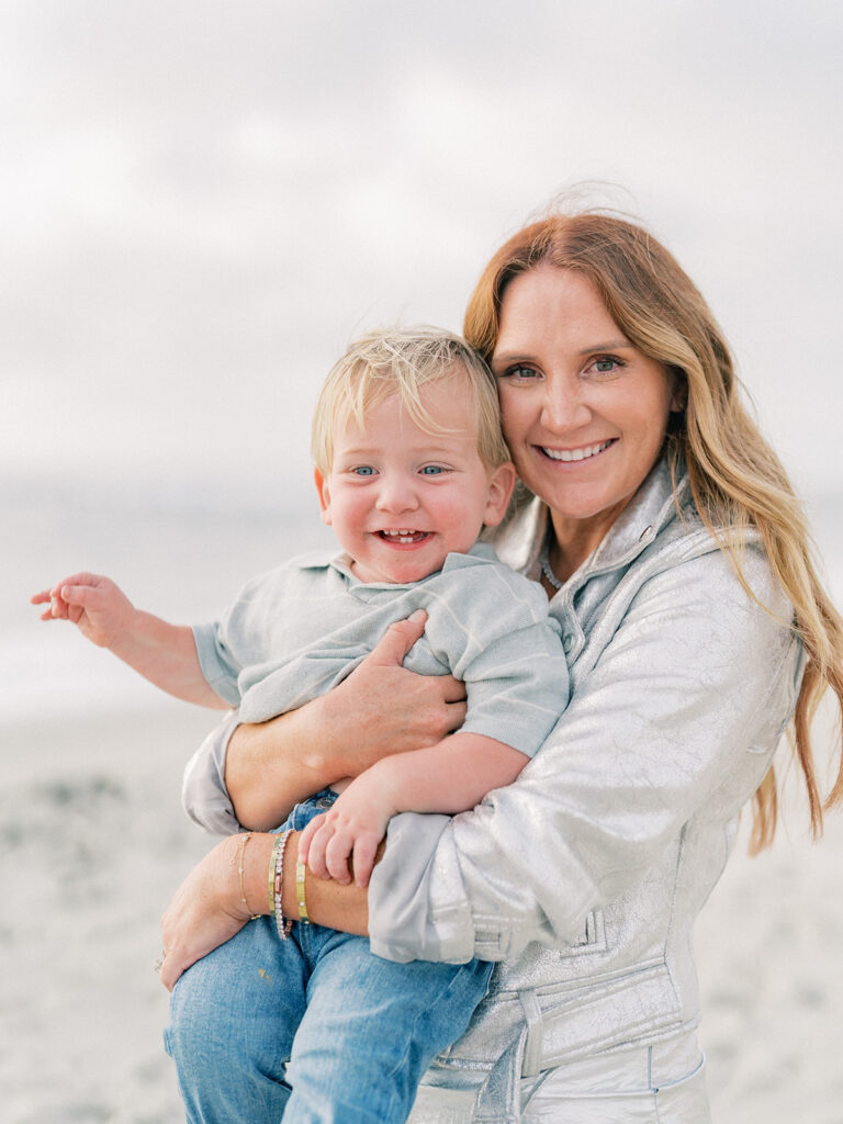 Mother carrying her toddler during La Jolla family photography session