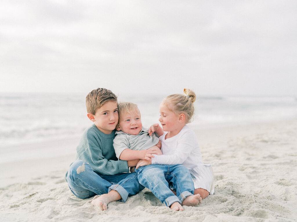 Three kids having fun at La Jolla shores