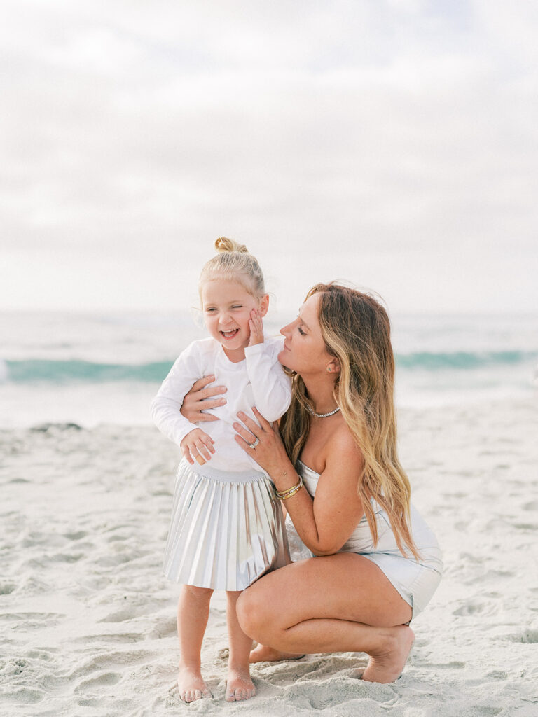 Little girl smiling as her mother looks at her