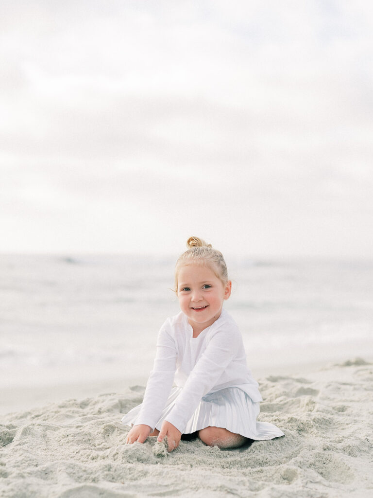 Little girl playing on the sand