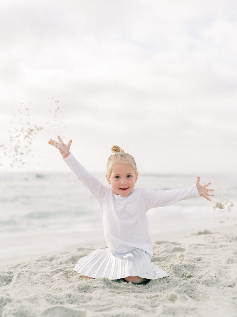 Little girl playing at the sand during La Jolla photography session