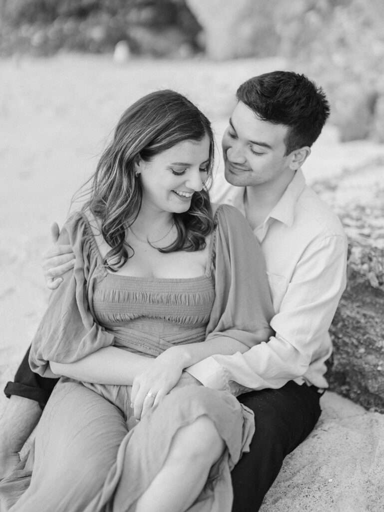 A couple sitting on the sand 