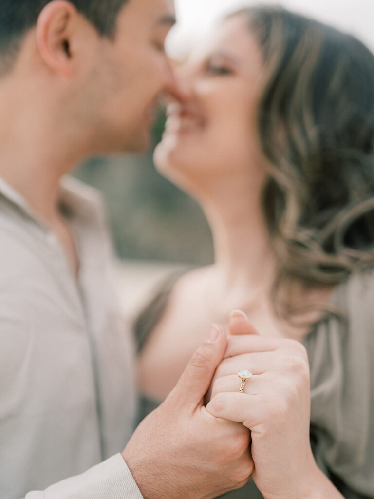 Close up photo showcasing the engagement ring during engagement session at Thousand steps beach in Laguna Beach