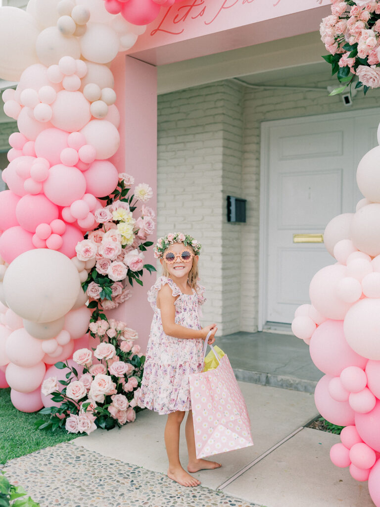 A little girl standing in front door 