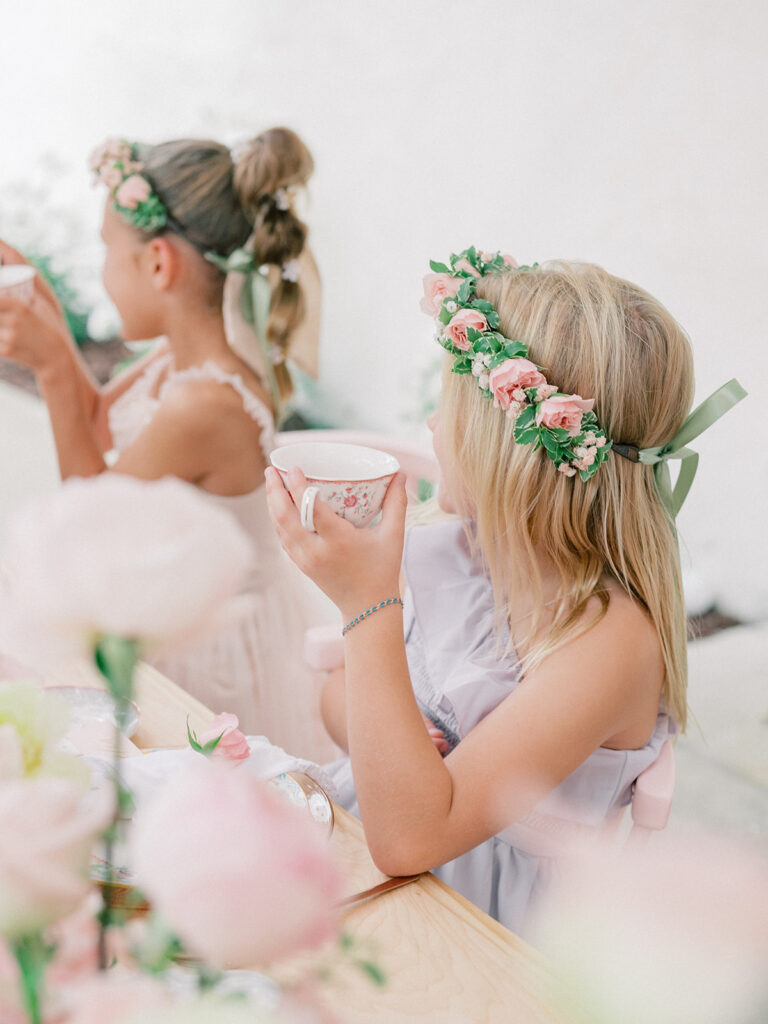 little girl holding a teacup