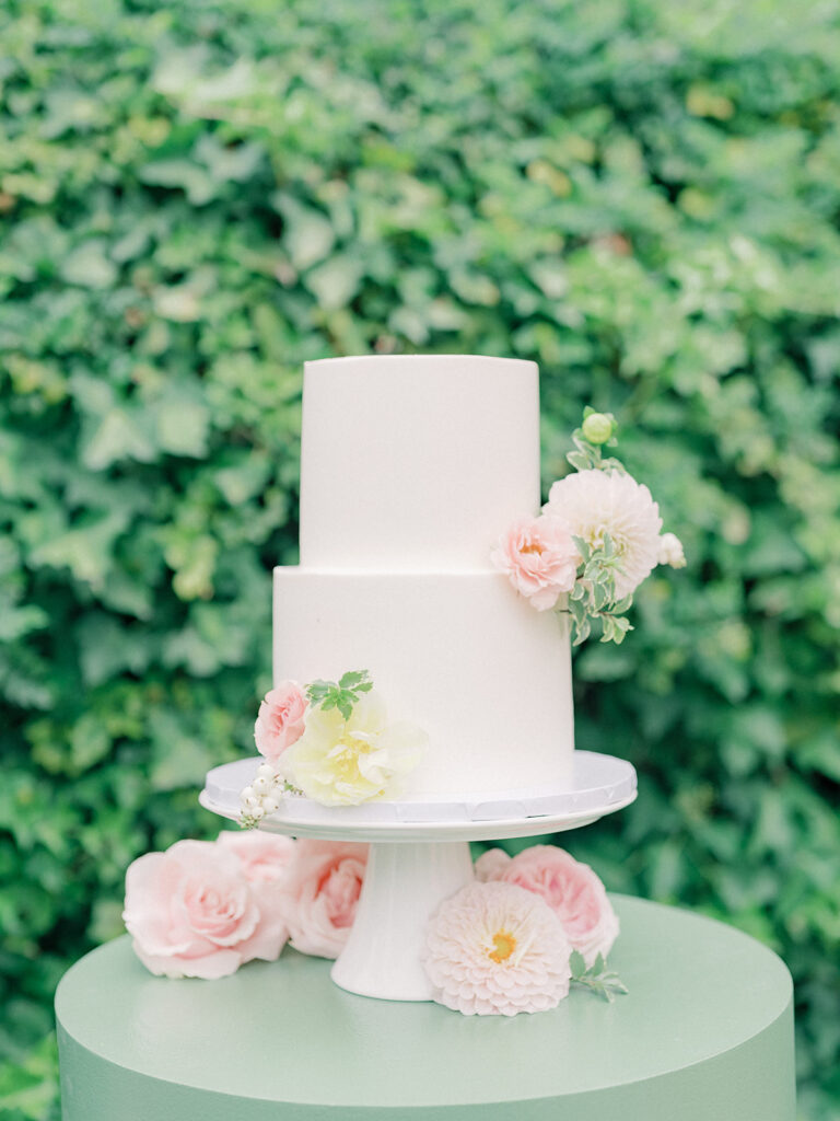 white cake with pastel flowers