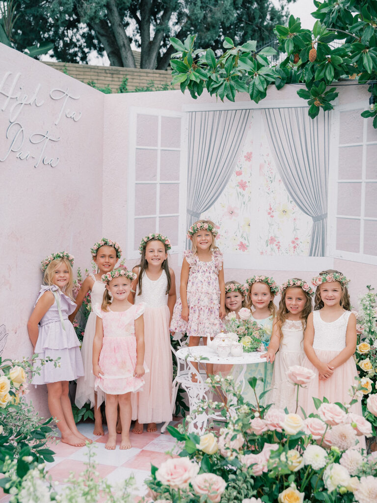 little girl with her friends during her birthday tea party