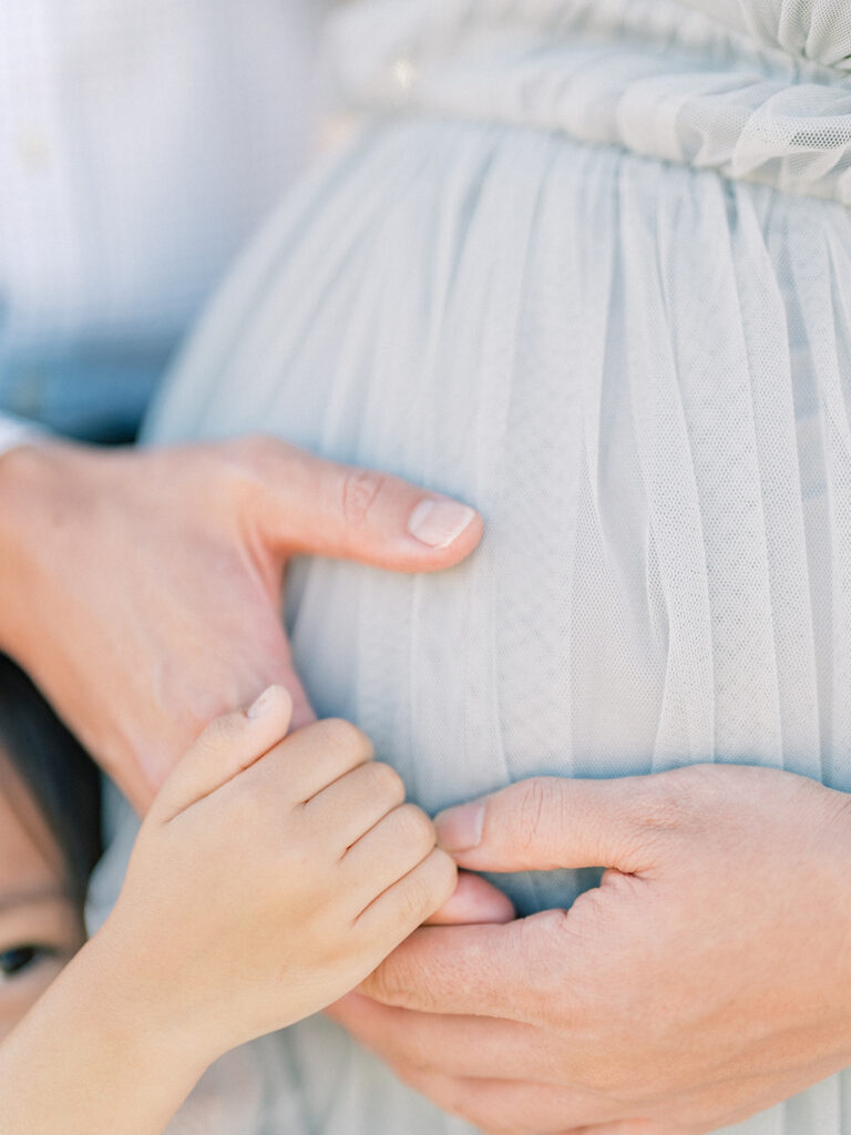 Hands on the pregnant woman tummy