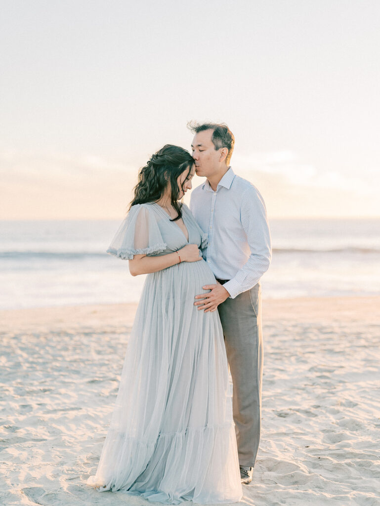 A couple in front of Coronado Beach captured by San Diego maternity photographer