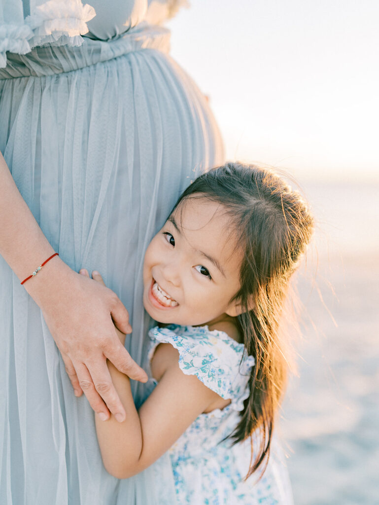 A kid hugging her mother