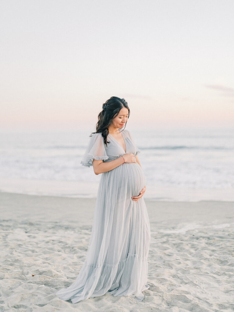 Mom to be standing in front of Coronado Beach