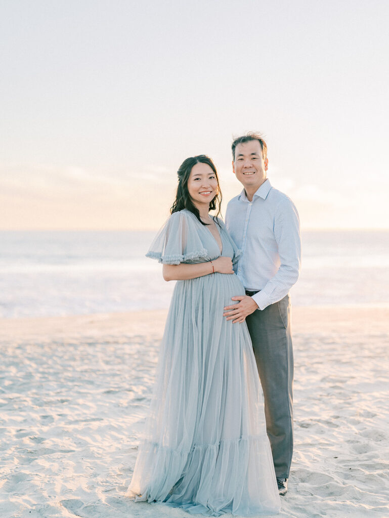 A couple having maternity shoot in front of Coronado Beach