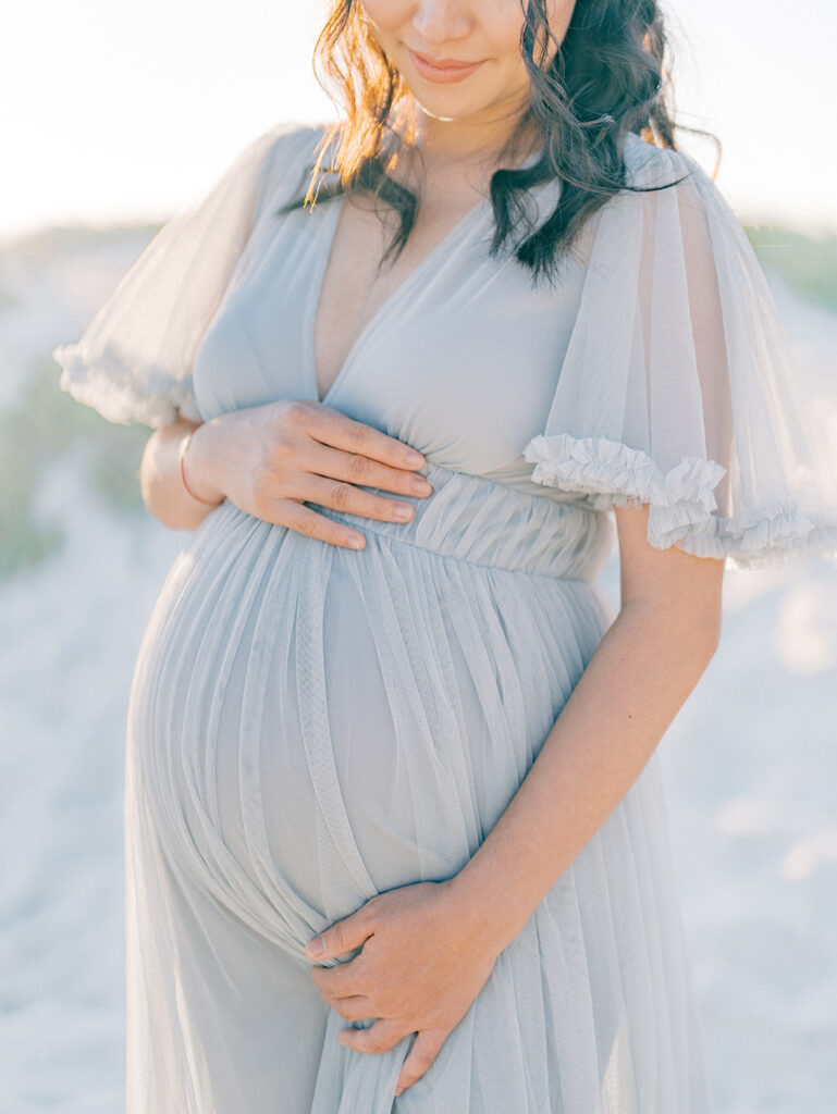 A mother holding his pregnant tummy