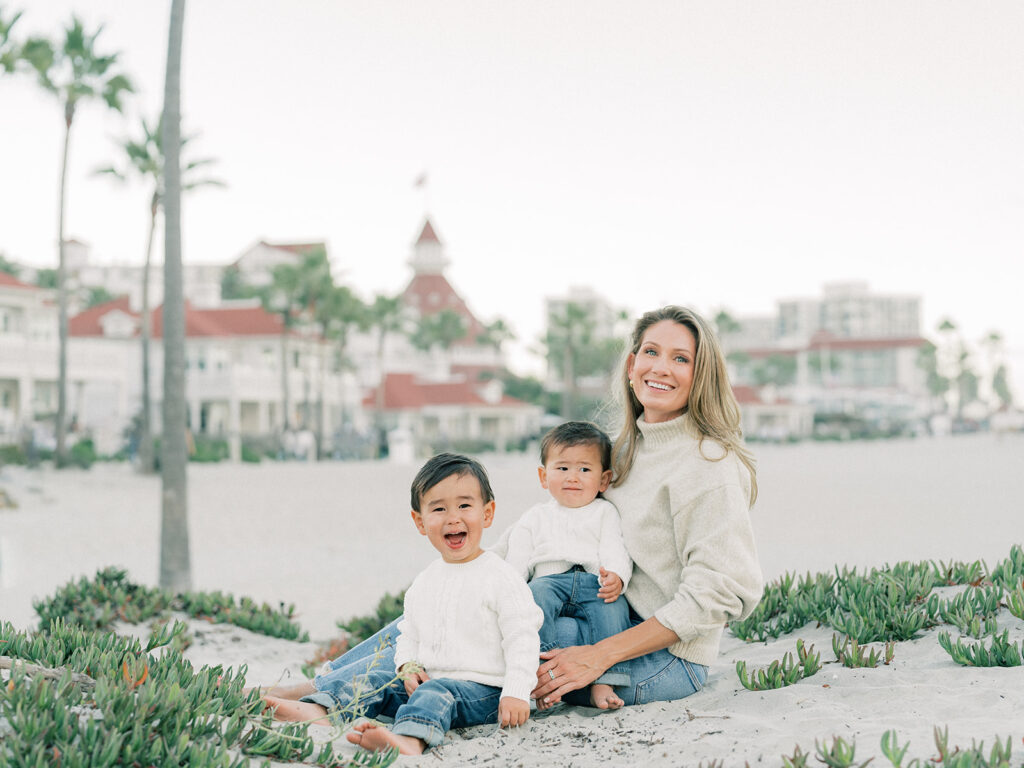 a family photo of a mother with her sons at coronado beach san diego