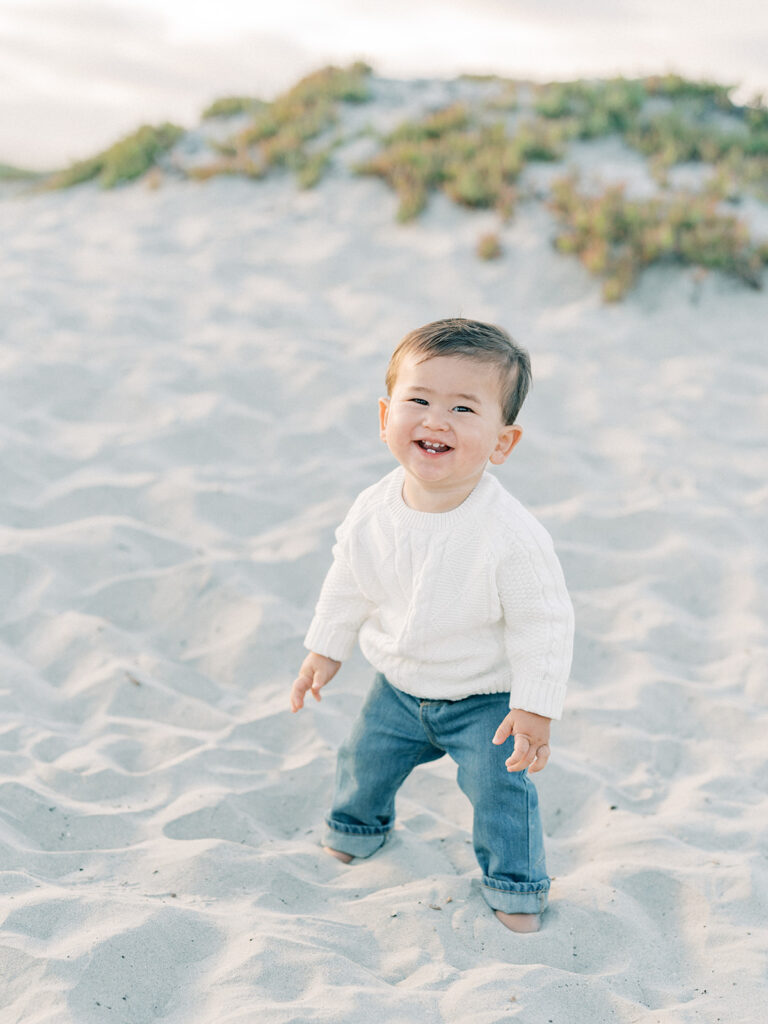 a toddler smiling at the camera 