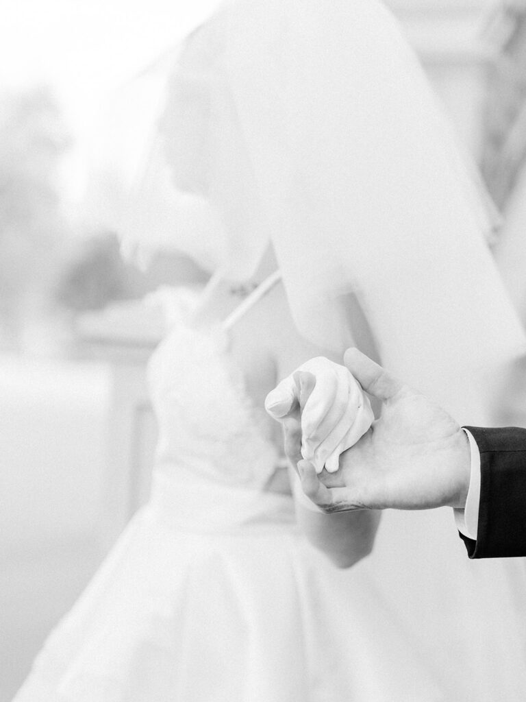 black and white photo of a couple holding each other's hand