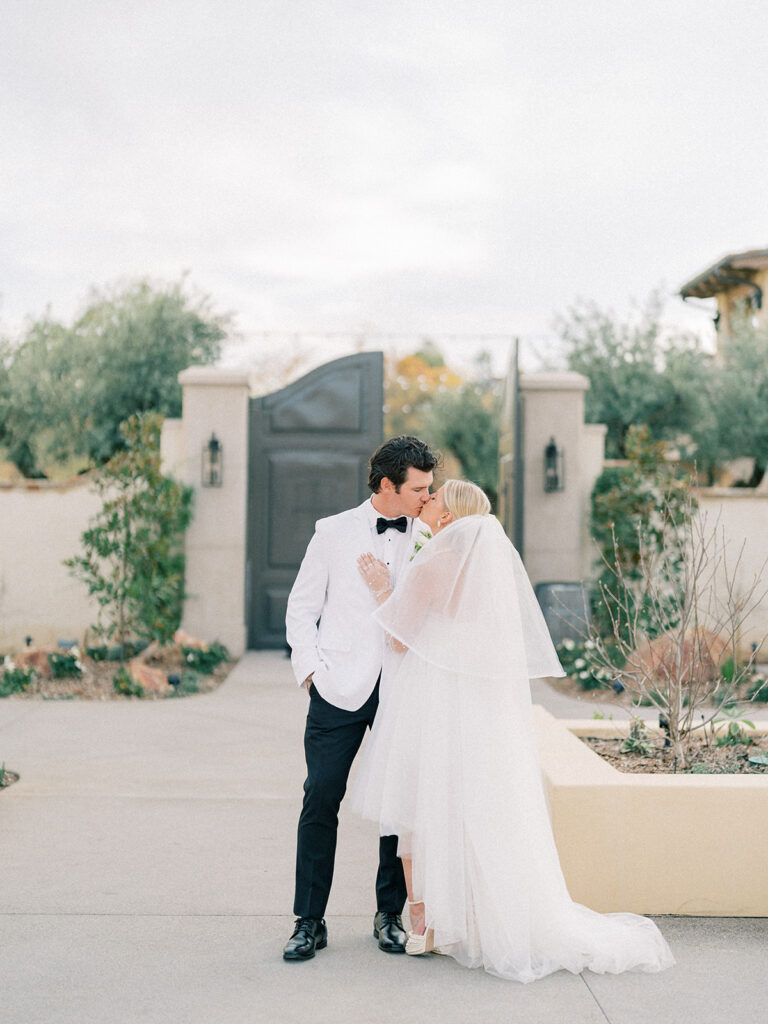 a bride and groom kissing at monserate winery