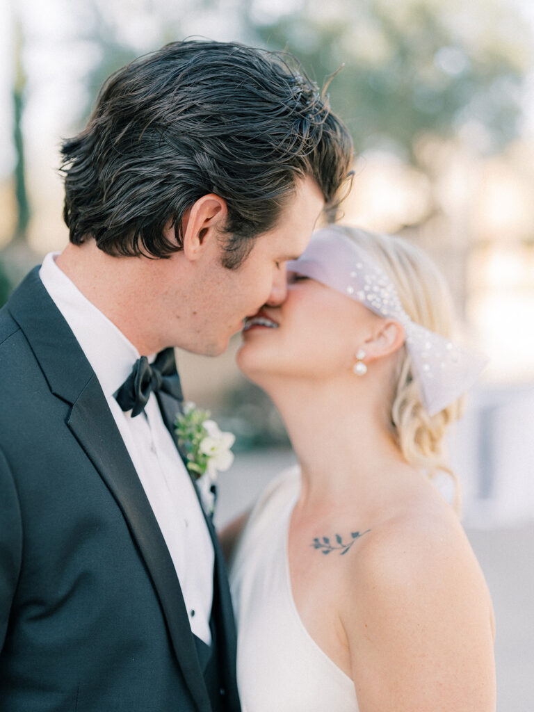 a bride and groom almost kissing each other