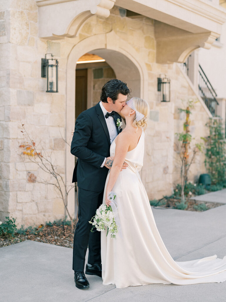 a couple kissing in front of monserate winery