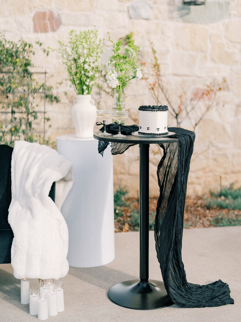 a white cake on top of black high table