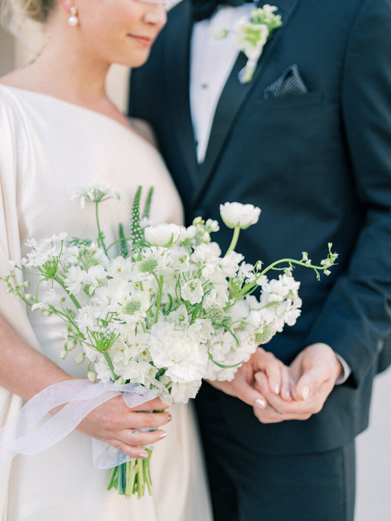 bride holding her white bouquet