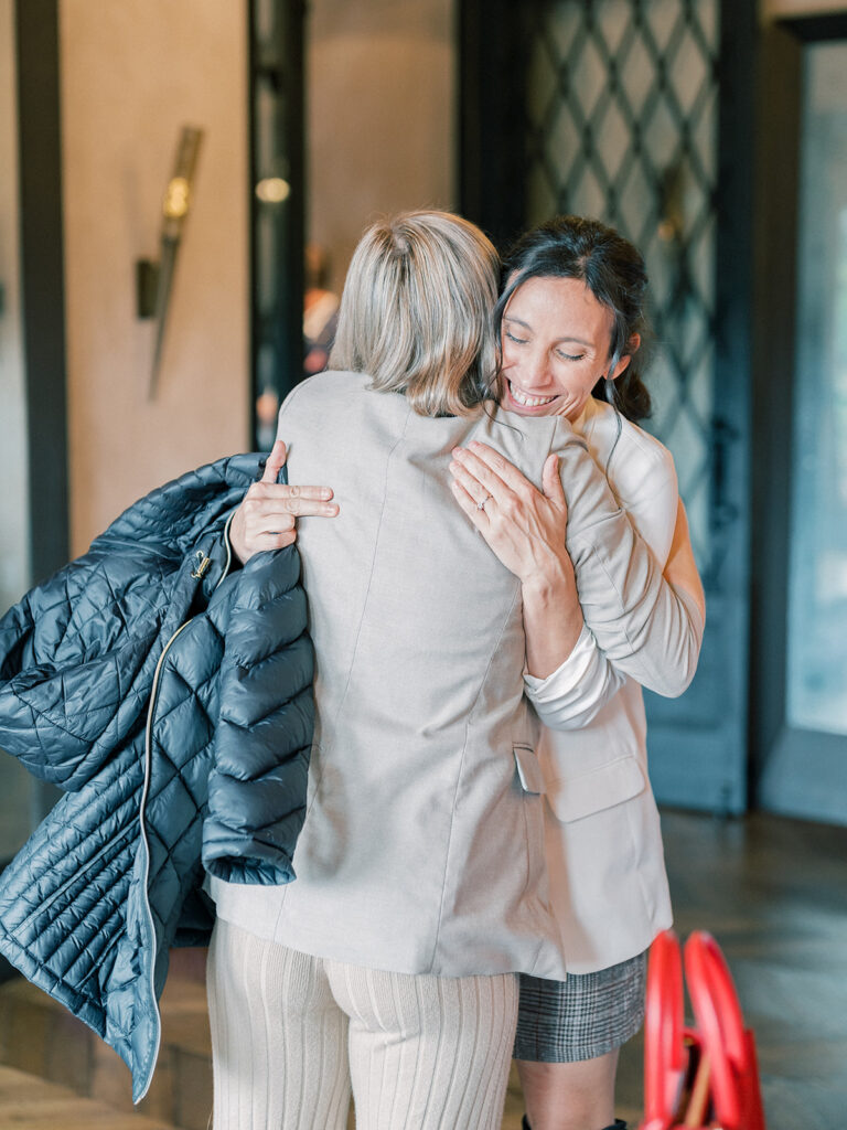 two woman hugging each other