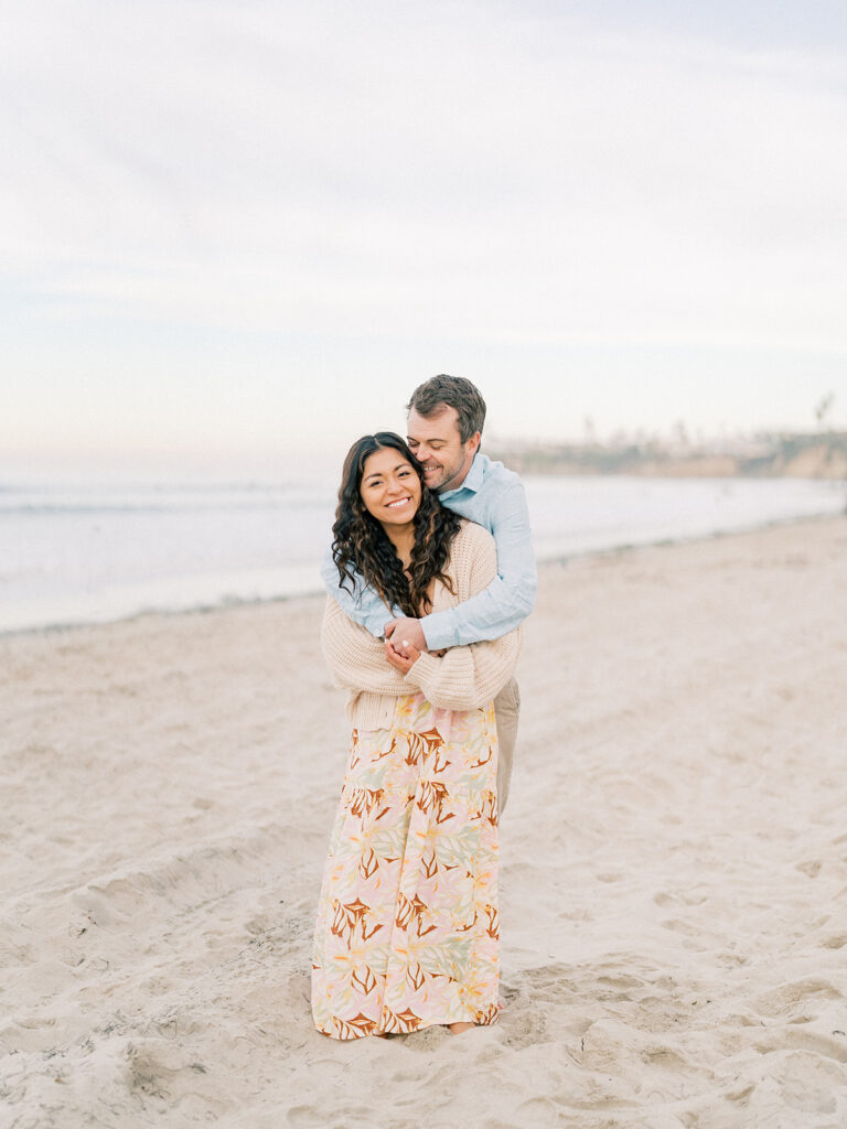 a couple hugging each other at laguna beach captured by san diego beach photographer