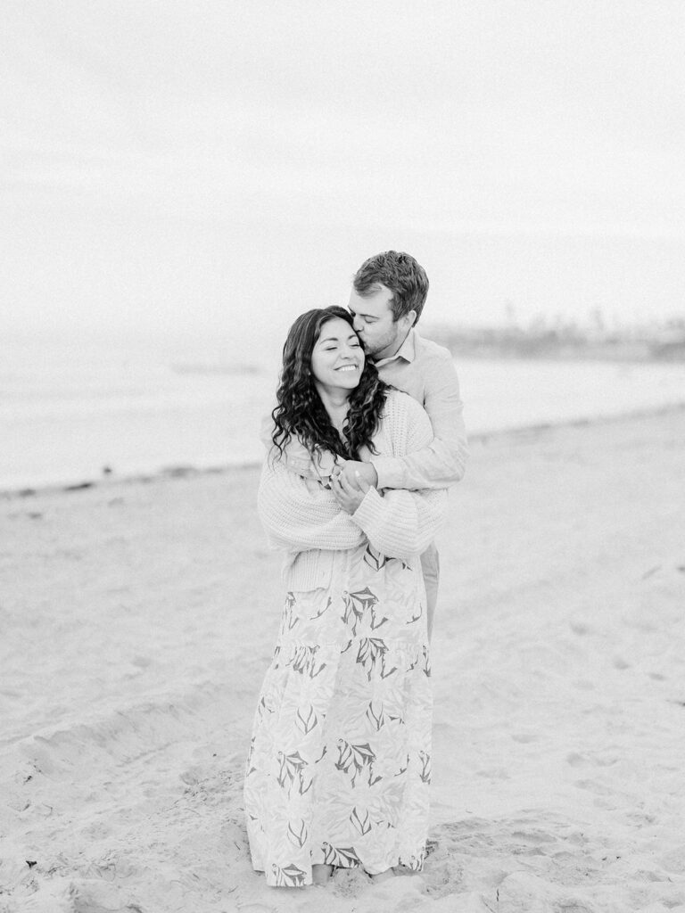 a black and white photo of a couple at pacific beach