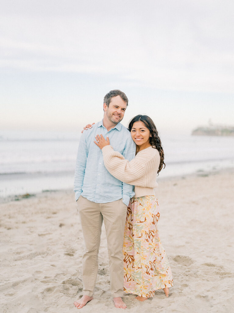 a couple standing at pacific beach