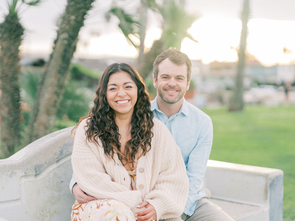 a couple sitting on a bench captured by san diego engagement photographer