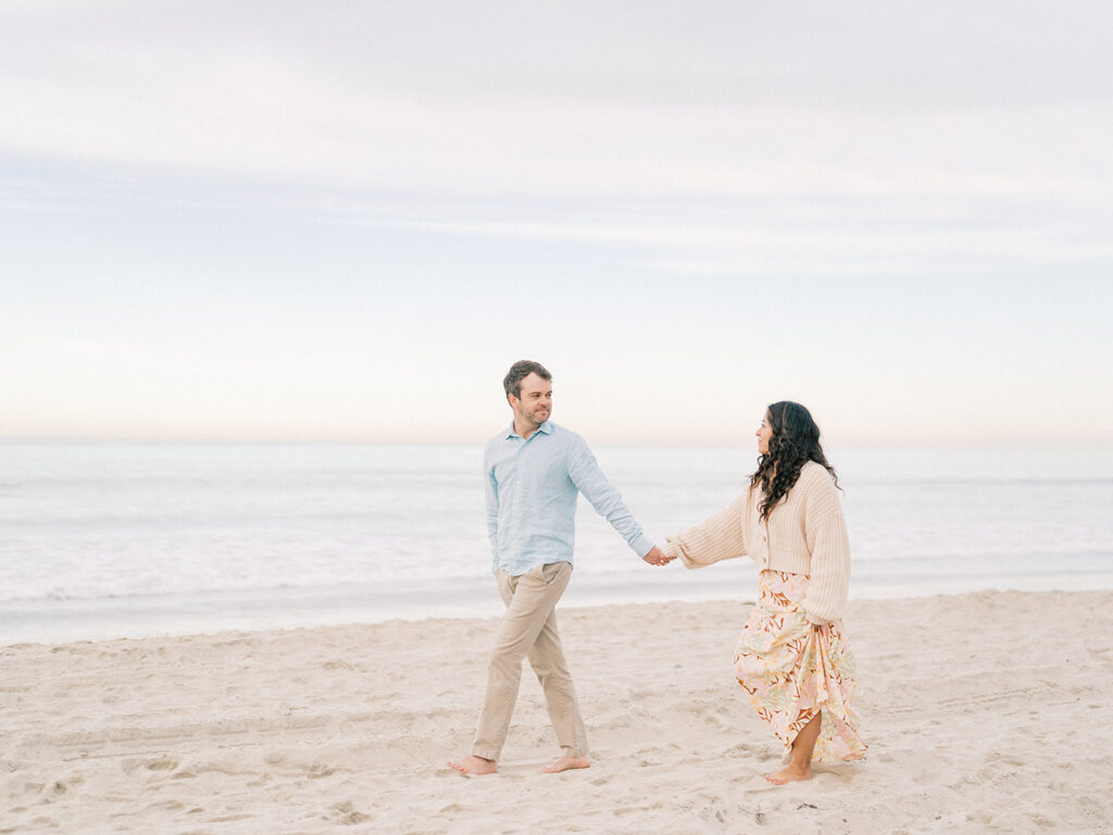 a couple walking by the beach captured by san diego beach photographer